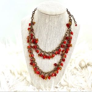 Coral colored double strand necklace.